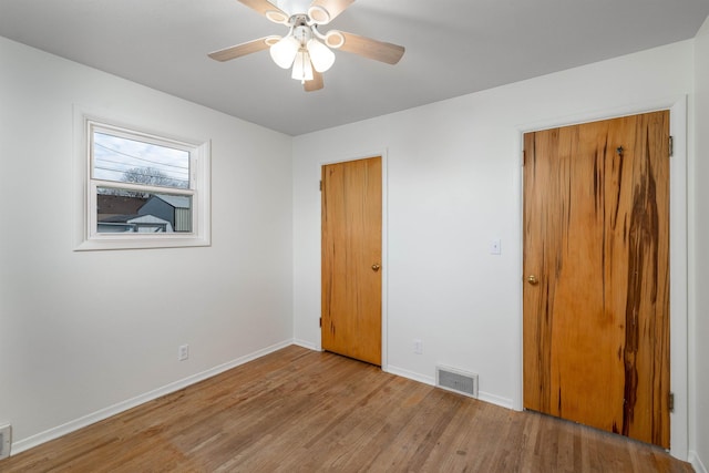 spare room with ceiling fan and light hardwood / wood-style flooring