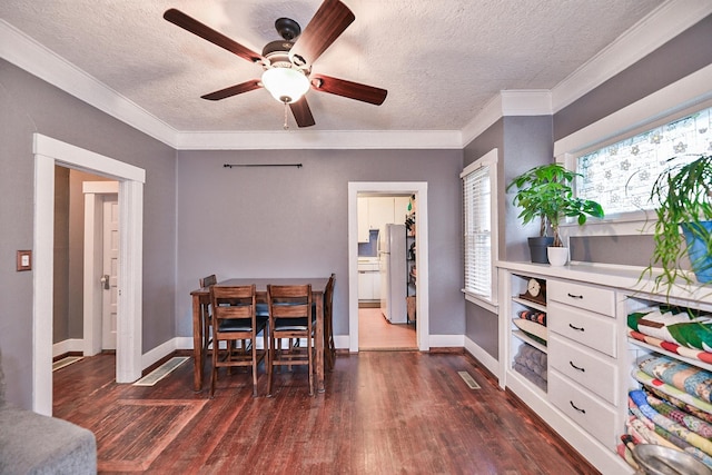 dining area with ornamental molding, a textured ceiling, ceiling fan, and dark hardwood / wood-style flooring