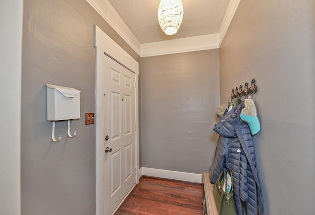 doorway to outside with dark hardwood / wood-style flooring and ornamental molding