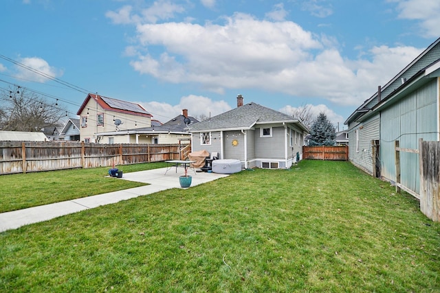 back of house featuring a patio area and a yard