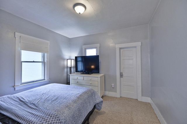 bedroom featuring light carpet