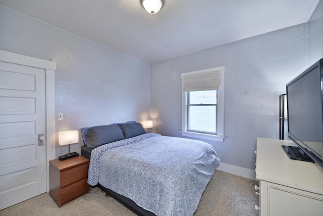 bedroom featuring light carpet