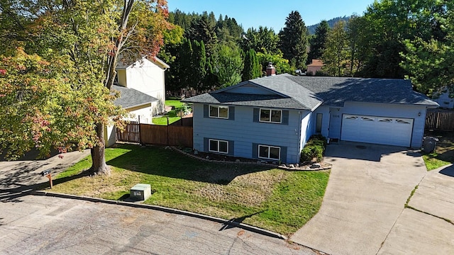 view of front of house with a garage and a front yard