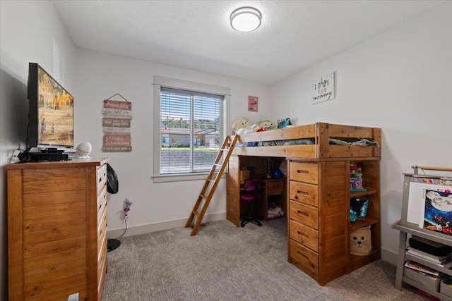 bedroom featuring a textured ceiling and light colored carpet