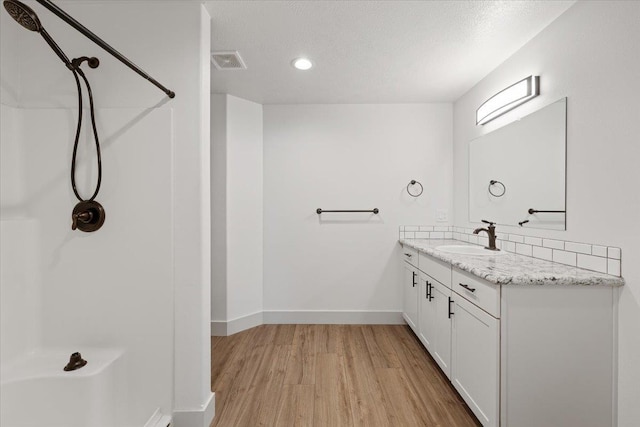 bathroom featuring vanity, a textured ceiling, and wood-type flooring