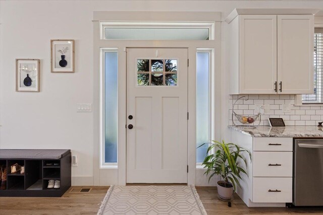 entryway with light hardwood / wood-style floors