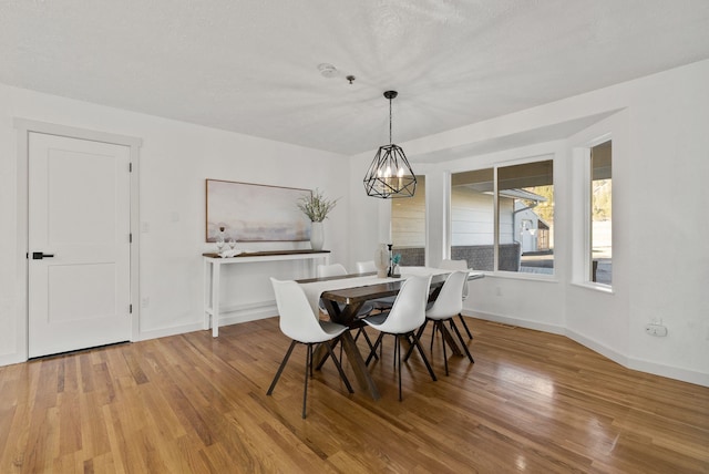 dining room with a chandelier and hardwood / wood-style floors