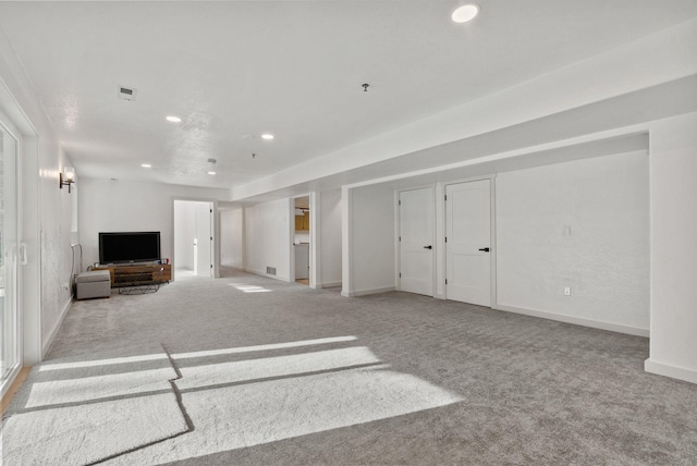 unfurnished living room featuring carpet flooring