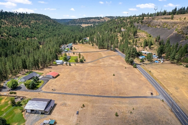 birds eye view of property with a rural view