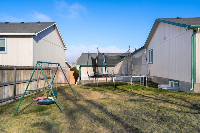 view of yard with a playground and a trampoline