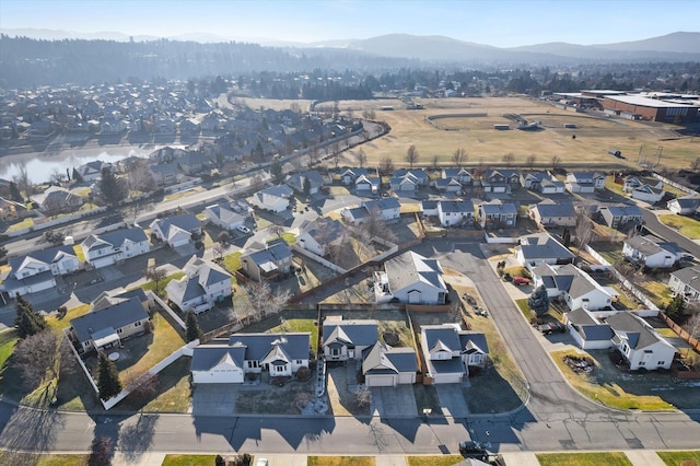 drone / aerial view with a water and mountain view