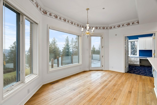 unfurnished dining area featuring light hardwood / wood-style flooring and plenty of natural light