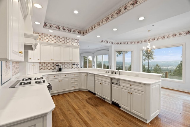 kitchen featuring sink, white cabinetry, and kitchen peninsula