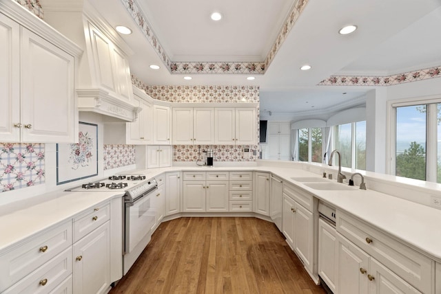 kitchen with sink, white cabinetry, white range with gas cooktop, and light hardwood / wood-style flooring