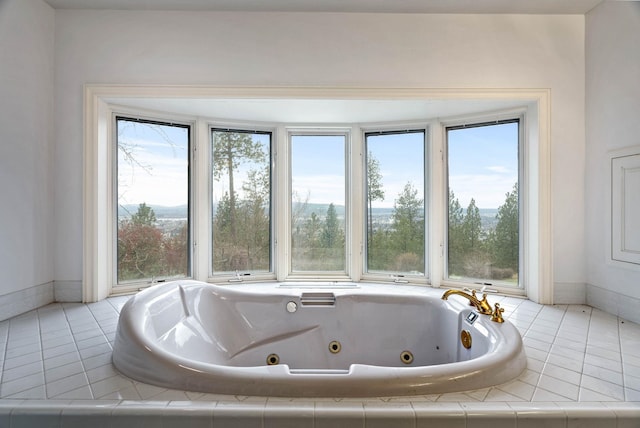 bathroom featuring a relaxing tiled tub