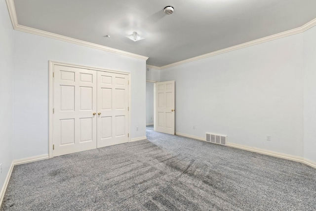 unfurnished bedroom featuring a closet, carpet, and ornamental molding