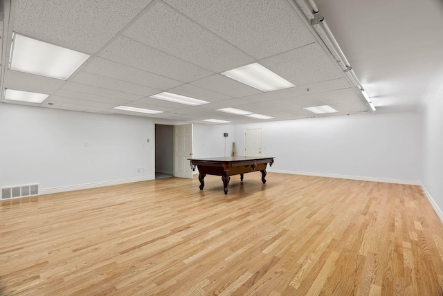 recreation room featuring light hardwood / wood-style floors and a drop ceiling