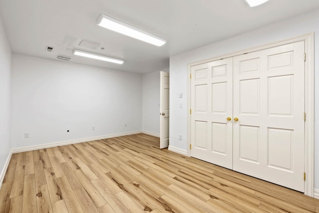 unfurnished bedroom with light wood-type flooring