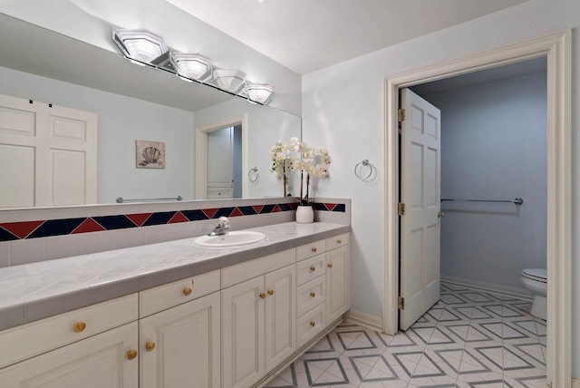 bathroom featuring toilet and vanity