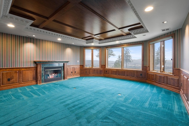 unfurnished living room with coffered ceiling, a premium fireplace, and carpet flooring