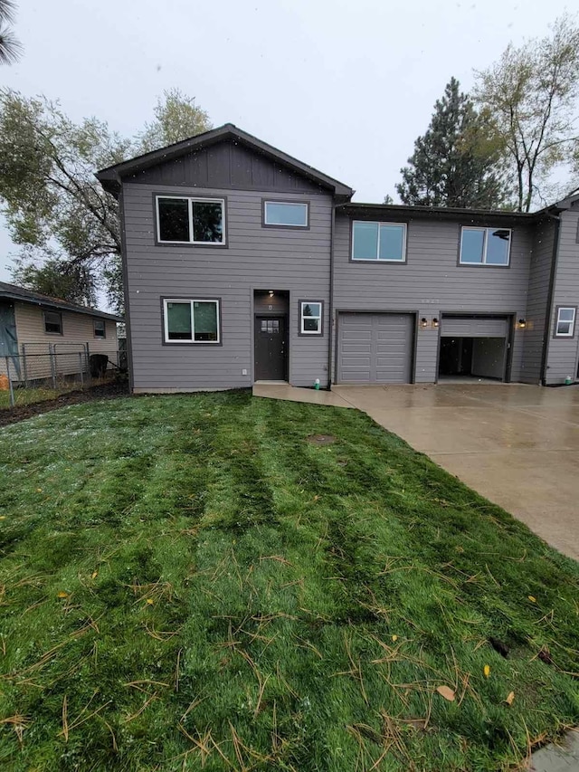 view of front of home featuring a front yard and a garage