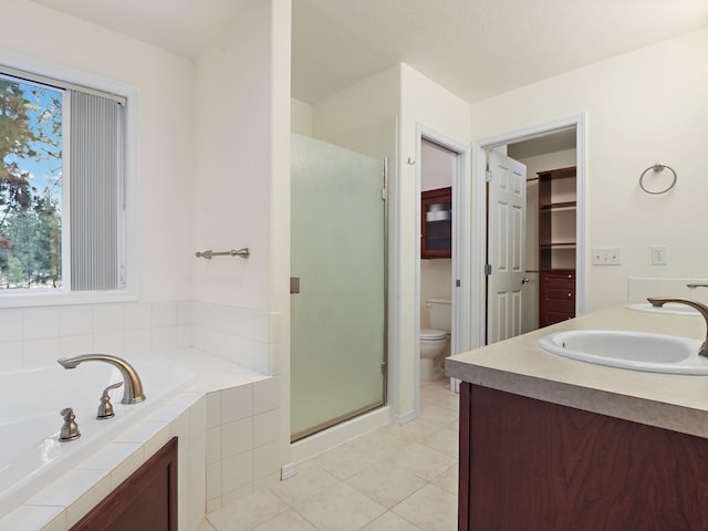 full bathroom with toilet, tile patterned floors, vanity, and independent shower and bath