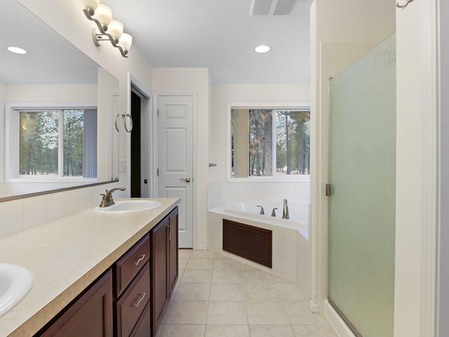 bathroom featuring vanity, tile patterned floors, and plus walk in shower