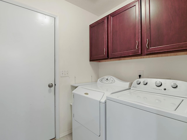 washroom with separate washer and dryer and cabinets