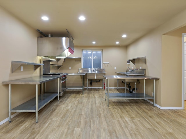 misc room featuring sink and light hardwood / wood-style flooring