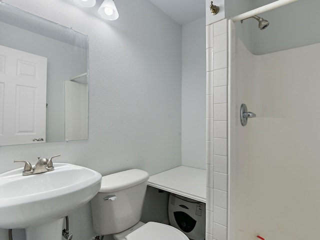 bathroom featuring sink, toilet, and walk in shower