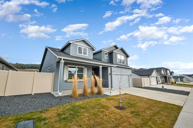 view of front facade featuring a porch, a garage, and a front yard