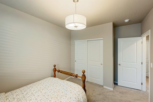 bedroom with light carpet and a closet