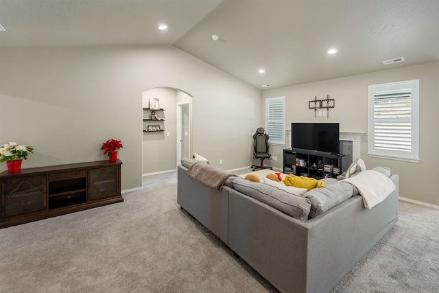 living room with lofted ceiling and light colored carpet