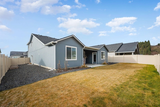 back of property featuring a lawn and a patio