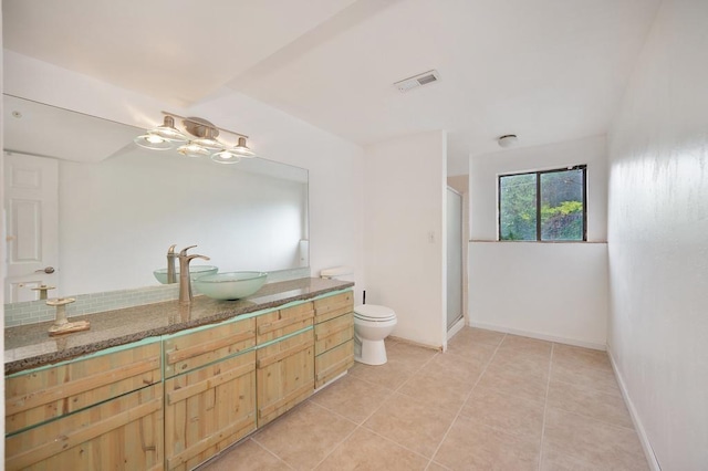 bathroom featuring tile patterned floors, walk in shower, toilet, and vanity