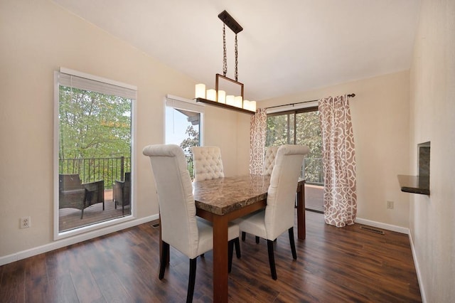 dining room featuring lofted ceiling and dark hardwood / wood-style flooring