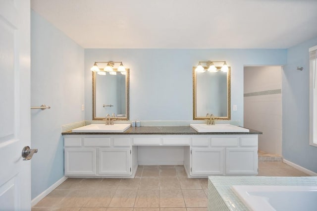 bathroom with a tub, tile patterned flooring, and vanity