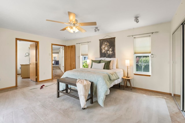 carpeted bedroom with ceiling fan and a closet