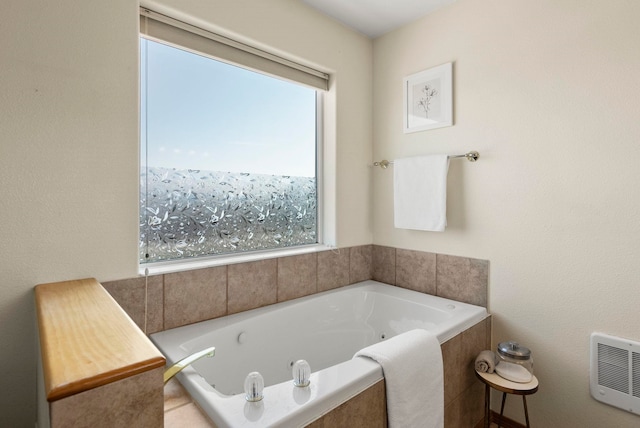 bathroom with tiled bath and heating unit