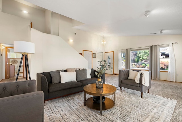 living room featuring vaulted ceiling and light carpet