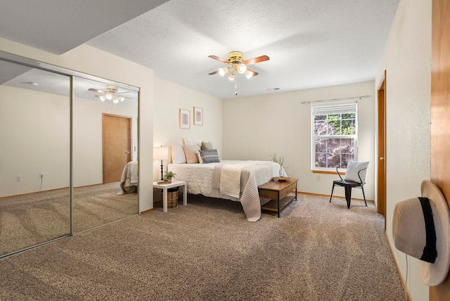 bedroom with carpet, a textured ceiling, and ceiling fan