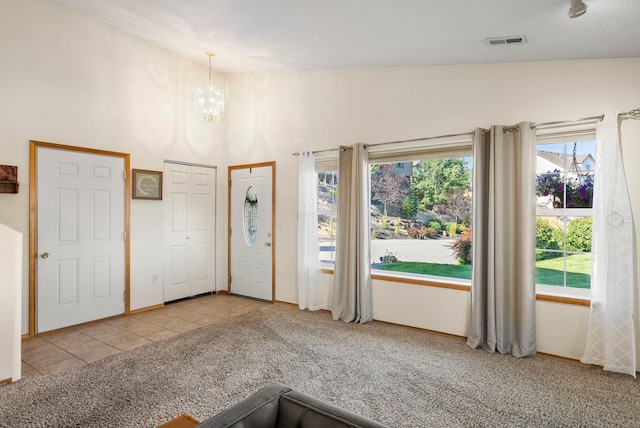 interior space with vaulted ceiling and a chandelier