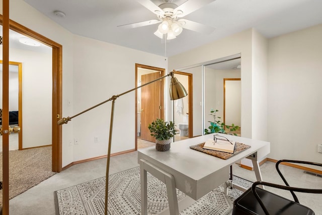 office space with light carpet, french doors, and ceiling fan