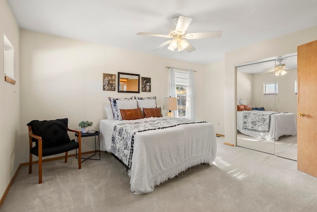 carpeted bedroom featuring ceiling fan and a closet