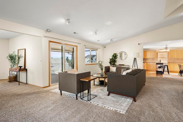 carpeted living room featuring lofted ceiling and ceiling fan