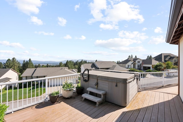 deck with a mountain view and a hot tub