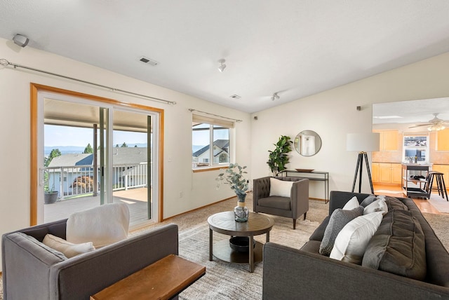 living room featuring lofted ceiling and ceiling fan