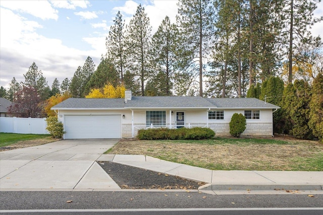 single story home with a garage and a front lawn