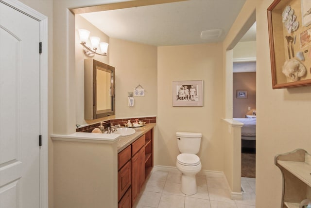 bathroom featuring vanity, decorative backsplash, tile patterned floors, and toilet