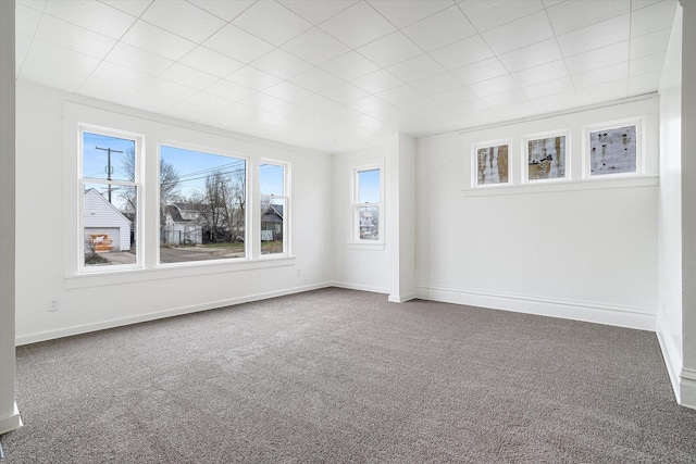 carpeted empty room with plenty of natural light